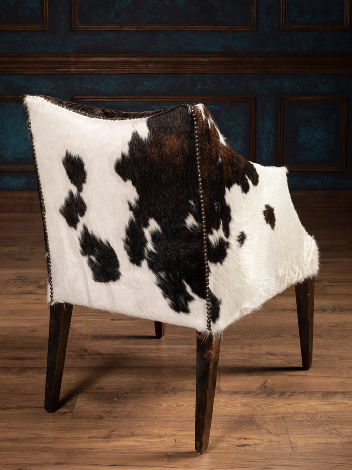 Outside back of brown leather chair featuring tri color cowhide back and arms