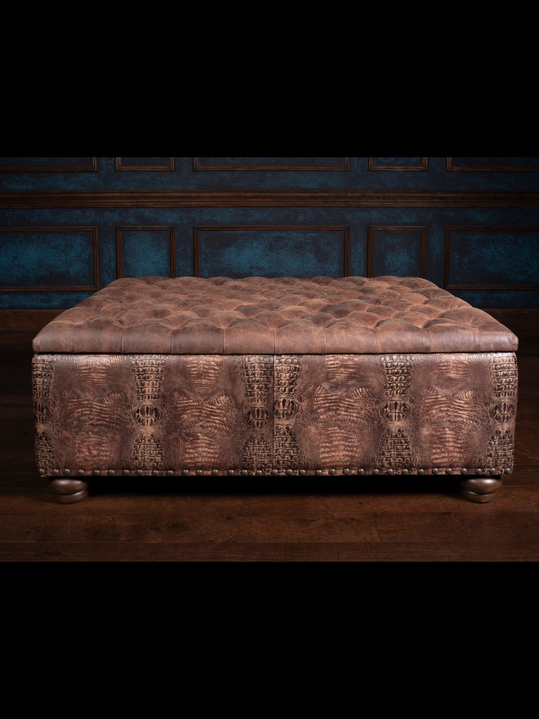 A tufted rectangle leather storage ottoman with a pecan brown color, featuring a textured surface and Nail Heads detailing.