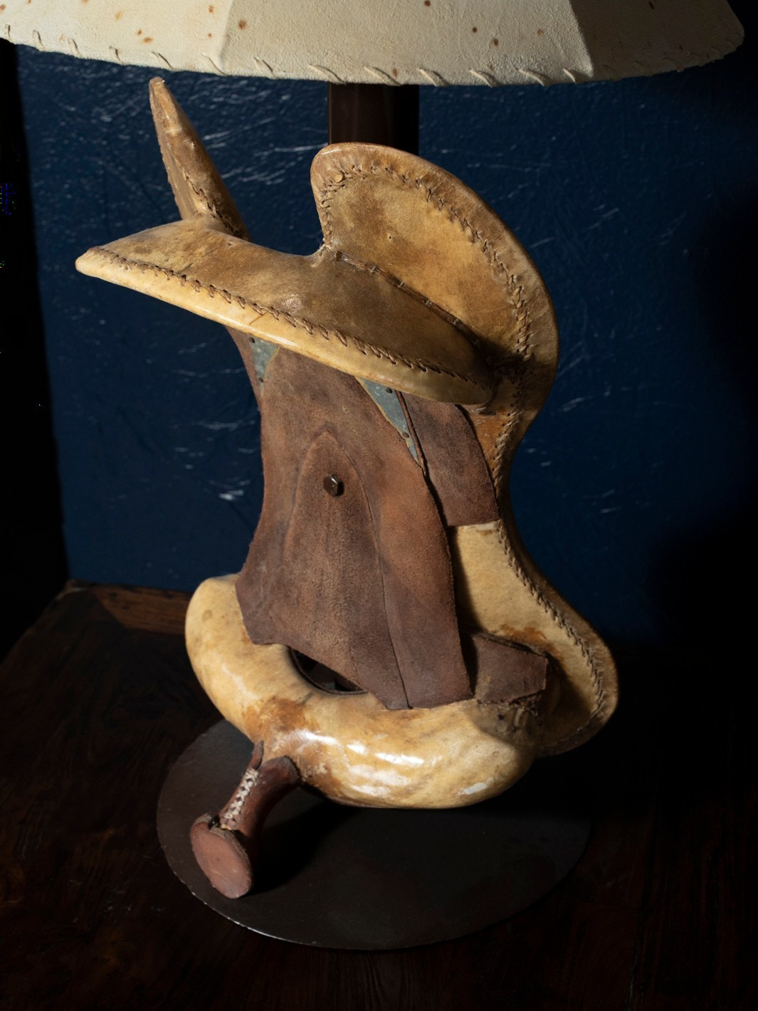 Close-up of iron saddle design on Saddle Cowboy table lamp showing western craftsmanship details