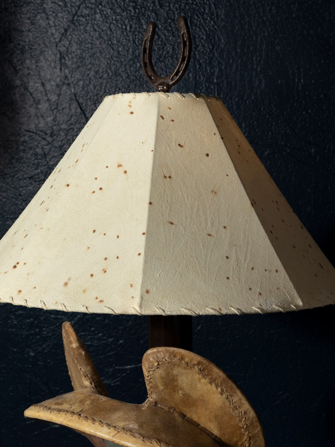 Western theme cowhide lamp shade with cowhide and a horseshoe finial on top