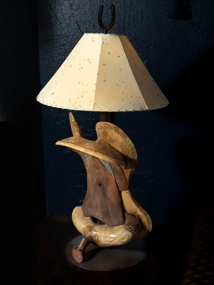Saddle Cowboy table lamp with iron saddle-inspired base and western theme cowhide lamp shade