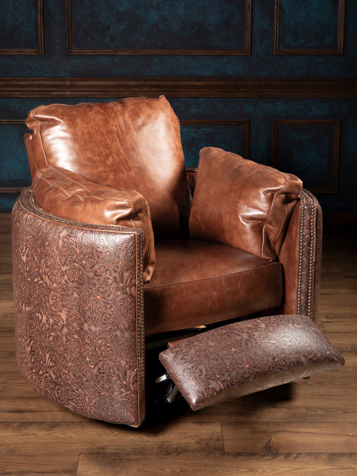 Western swivel recliner in open position with extended tooled leather footrest and plush saddle leather cushioning.