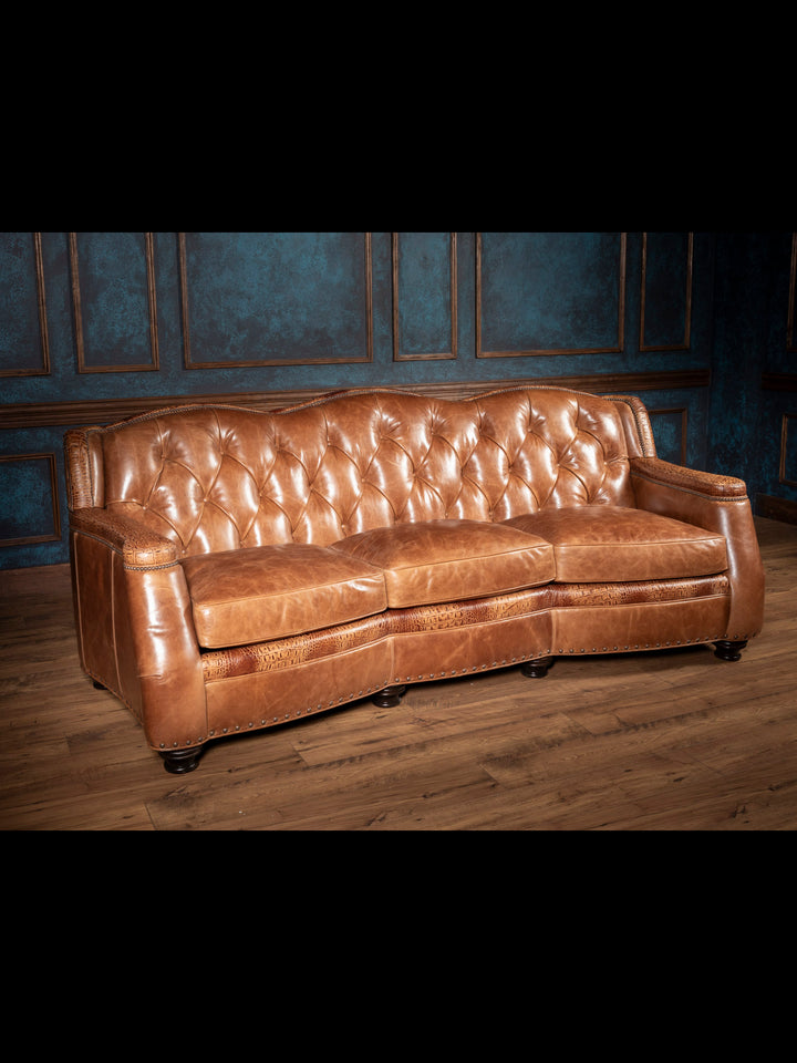 Brown leather sofa in a room with wooden floor and blue walls