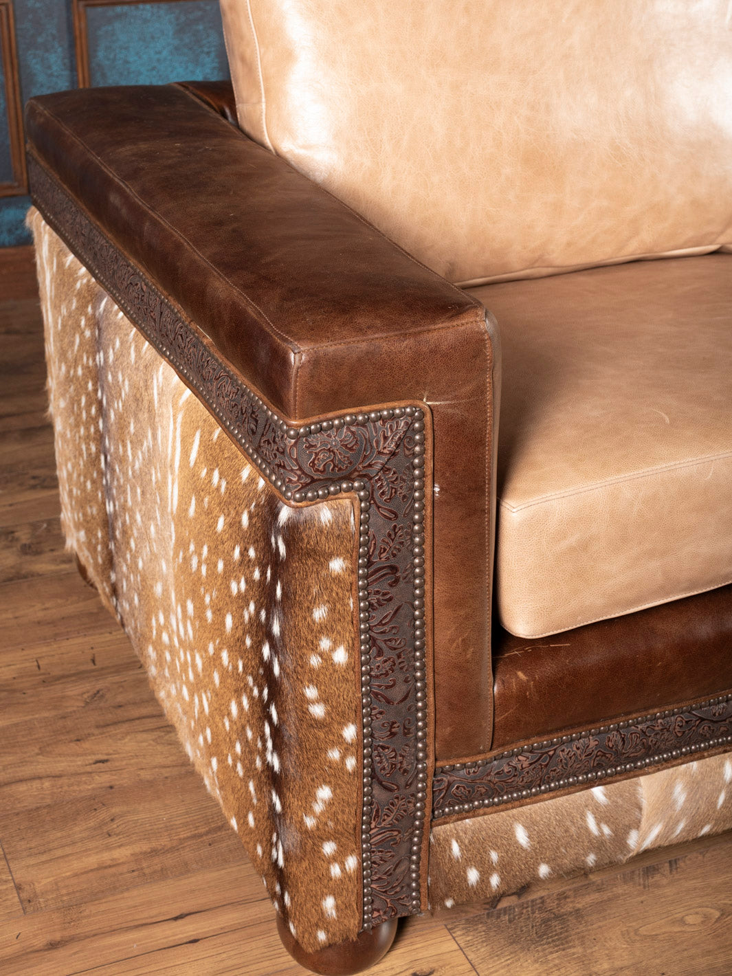 Detail of nailhead trim and tan buffalo leather upholstery on the Sandstone Axis Leather Sofa