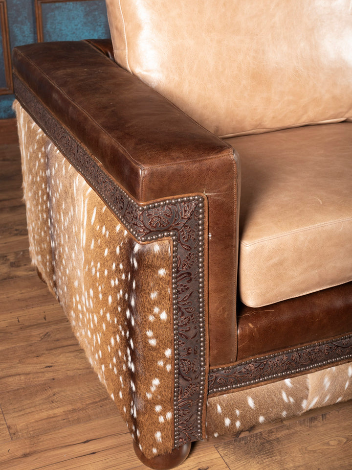 Detail of nailhead trim and tan buffalo leather upholstery on the Sandstone Axis Leather Sofa