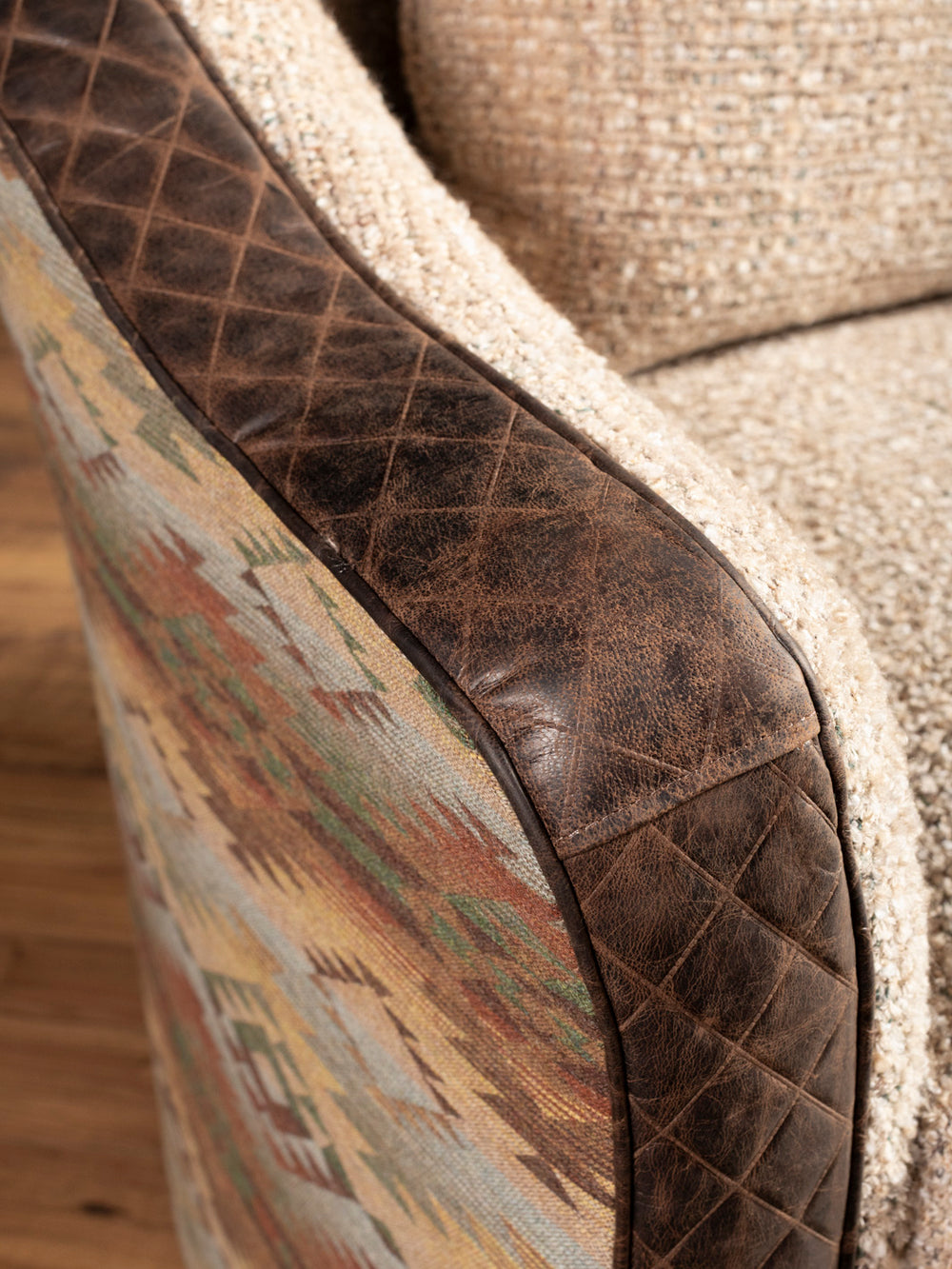 Close-up of side detail: Brown quilted leather trim with Southwestern textile panel