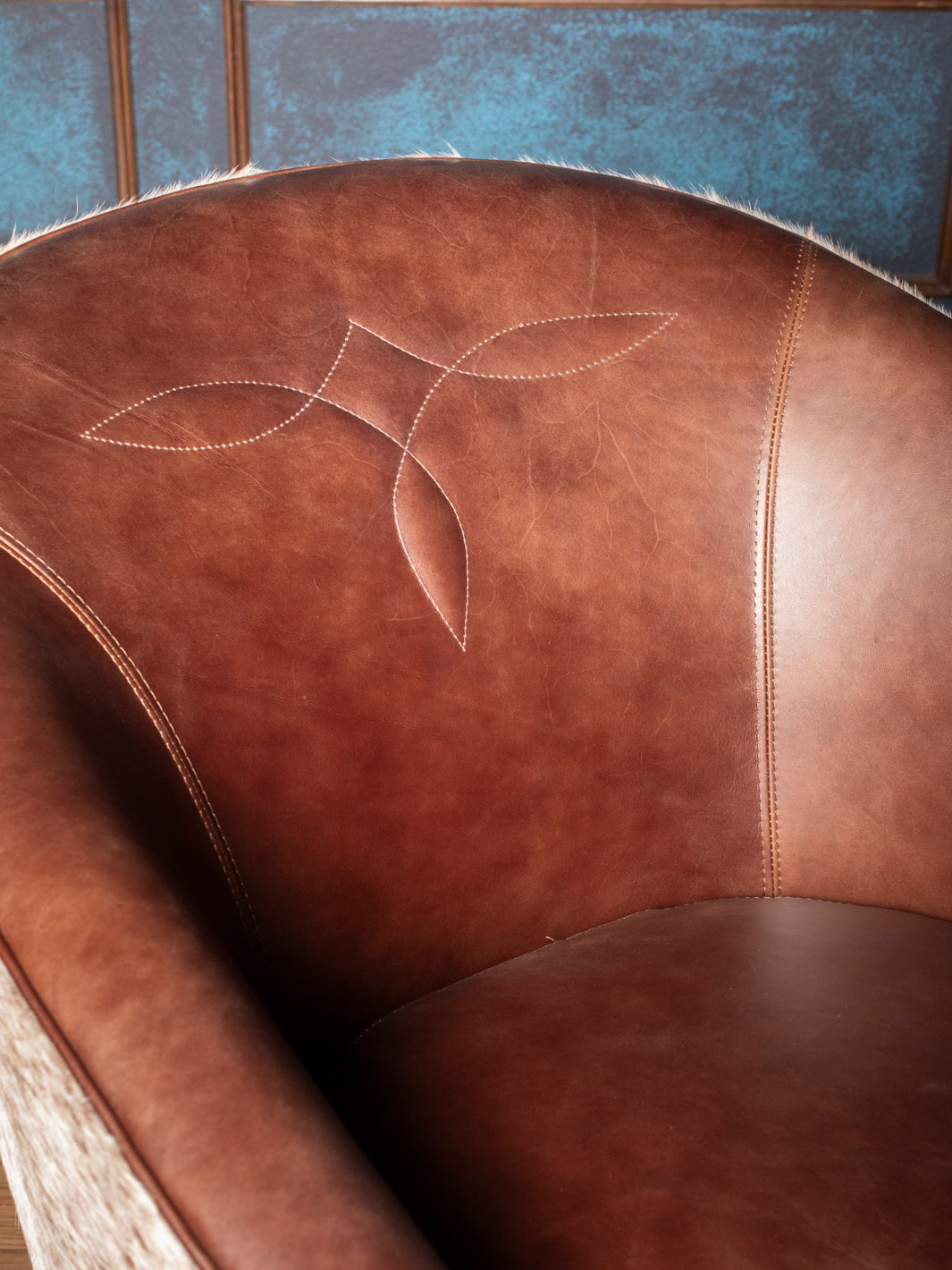 Boot stitch design on inside back of chocolate brown Western leather accent chair