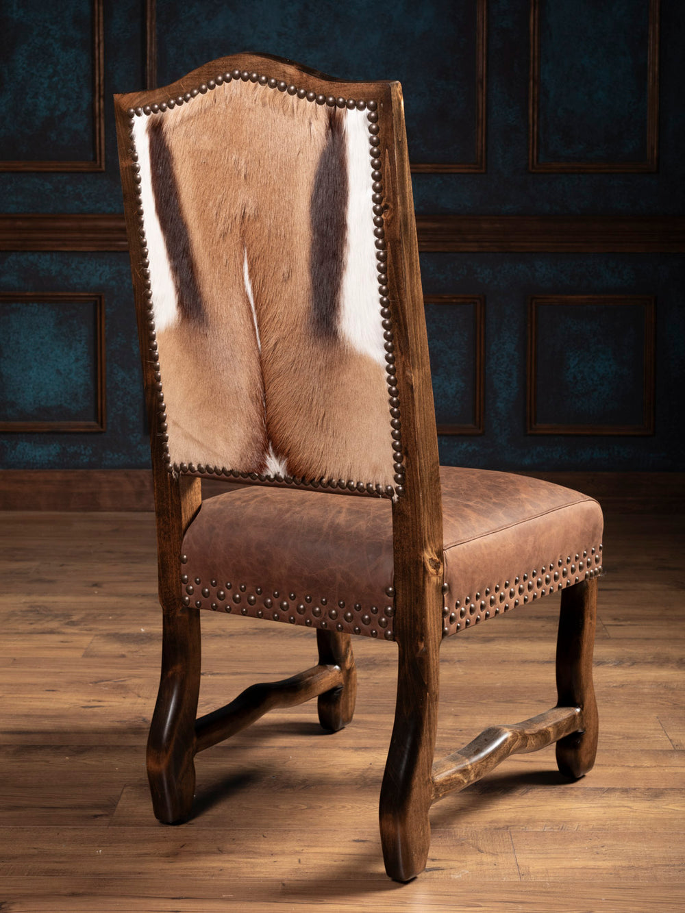 Back side angle of leather chair featuring springbok hair on hide back paneling