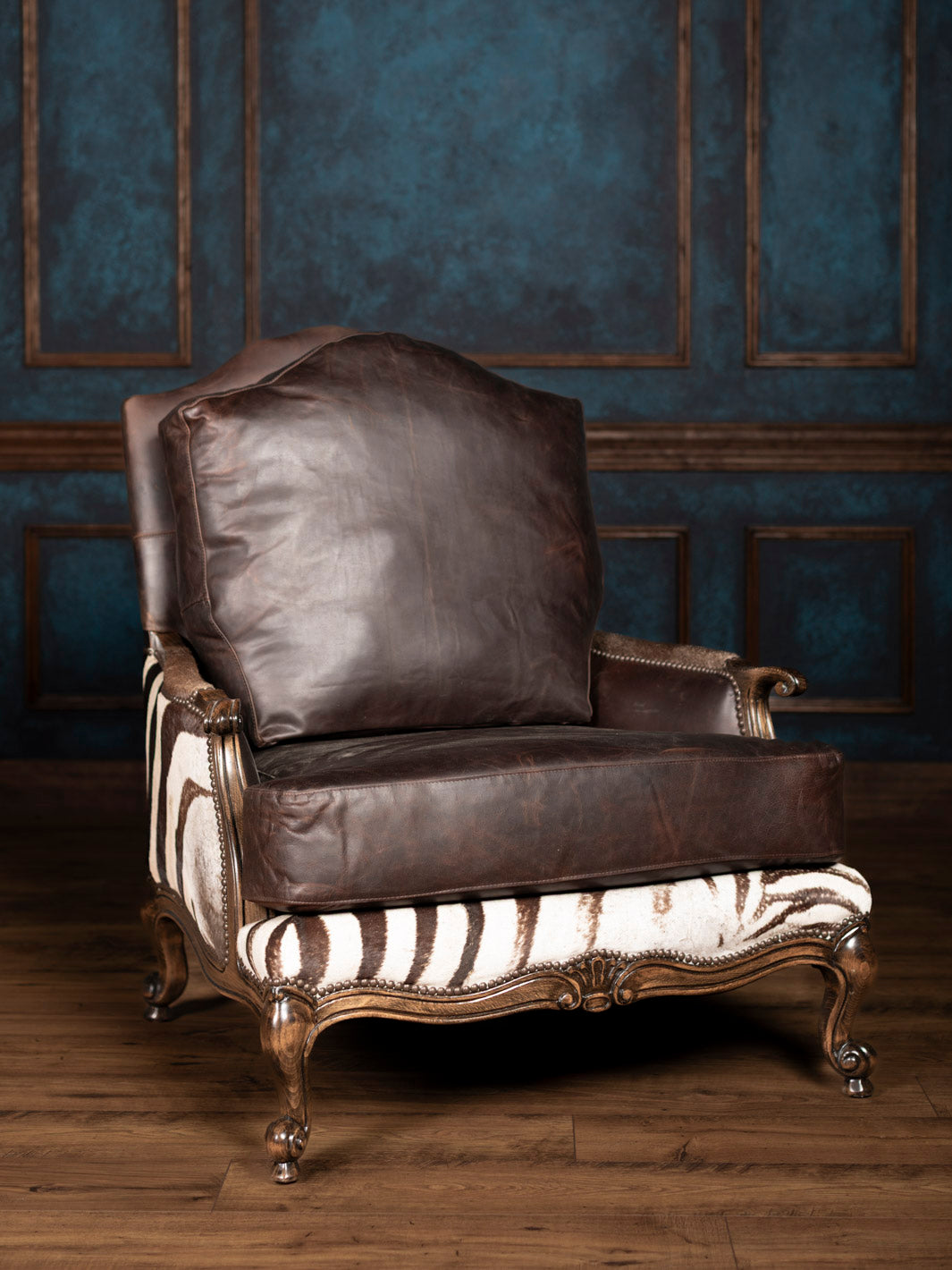 Zebra hide leather accent chair with handcrafted details and curved wood arms