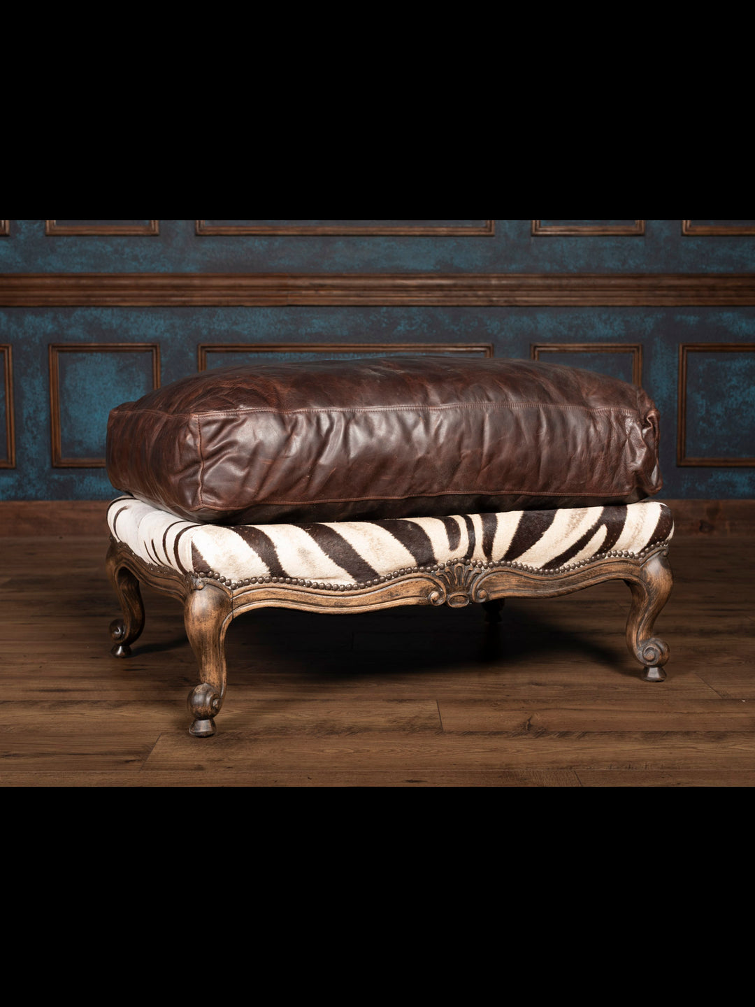 Luxury zebra leather ottoman with dark brown cushion and carved wood legs – handcrafted exotic furniture