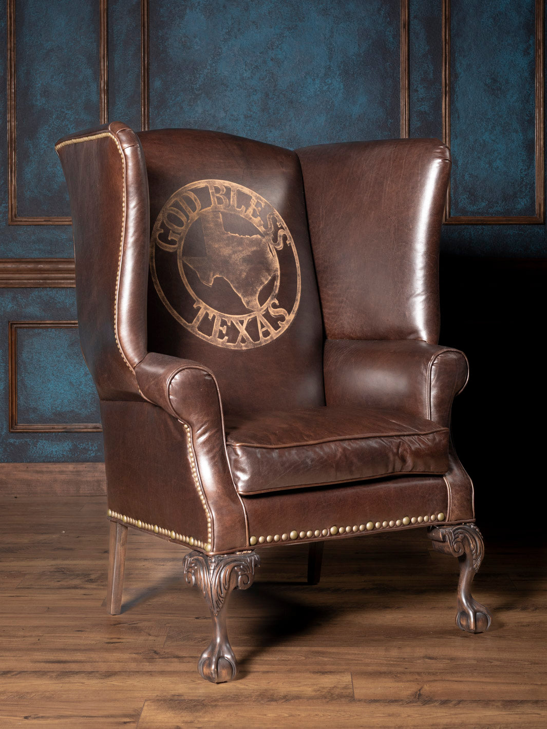 Front view of handcrafted Texas Legacy Leather Wingback Chair with etched “God Bless Texas” leather and clawfoot legs