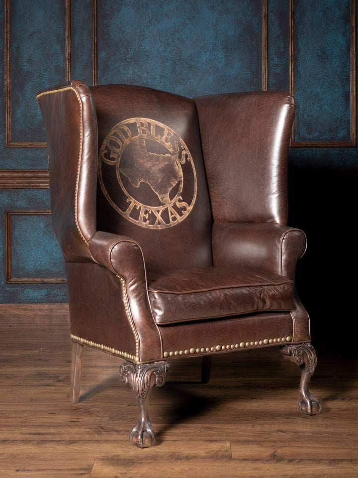 Front view of handcrafted Texas Legacy Leather Wingback Chair with etched “God Bless Texas” leather and clawfoot legs