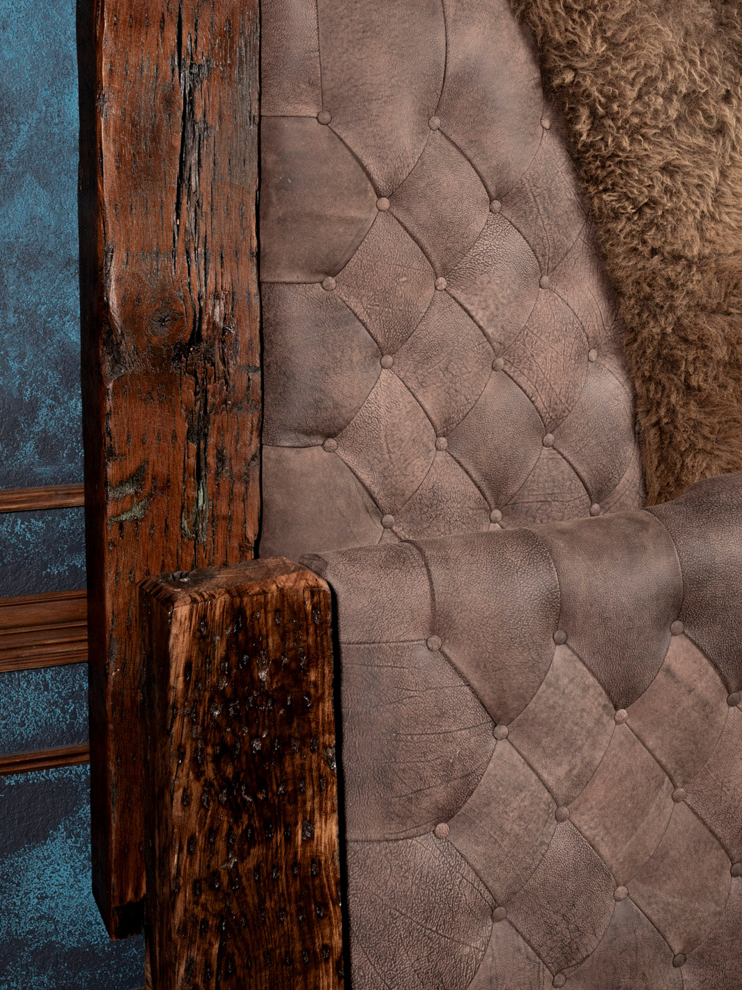 Close up of reclaimed wood posters and tufted bed
