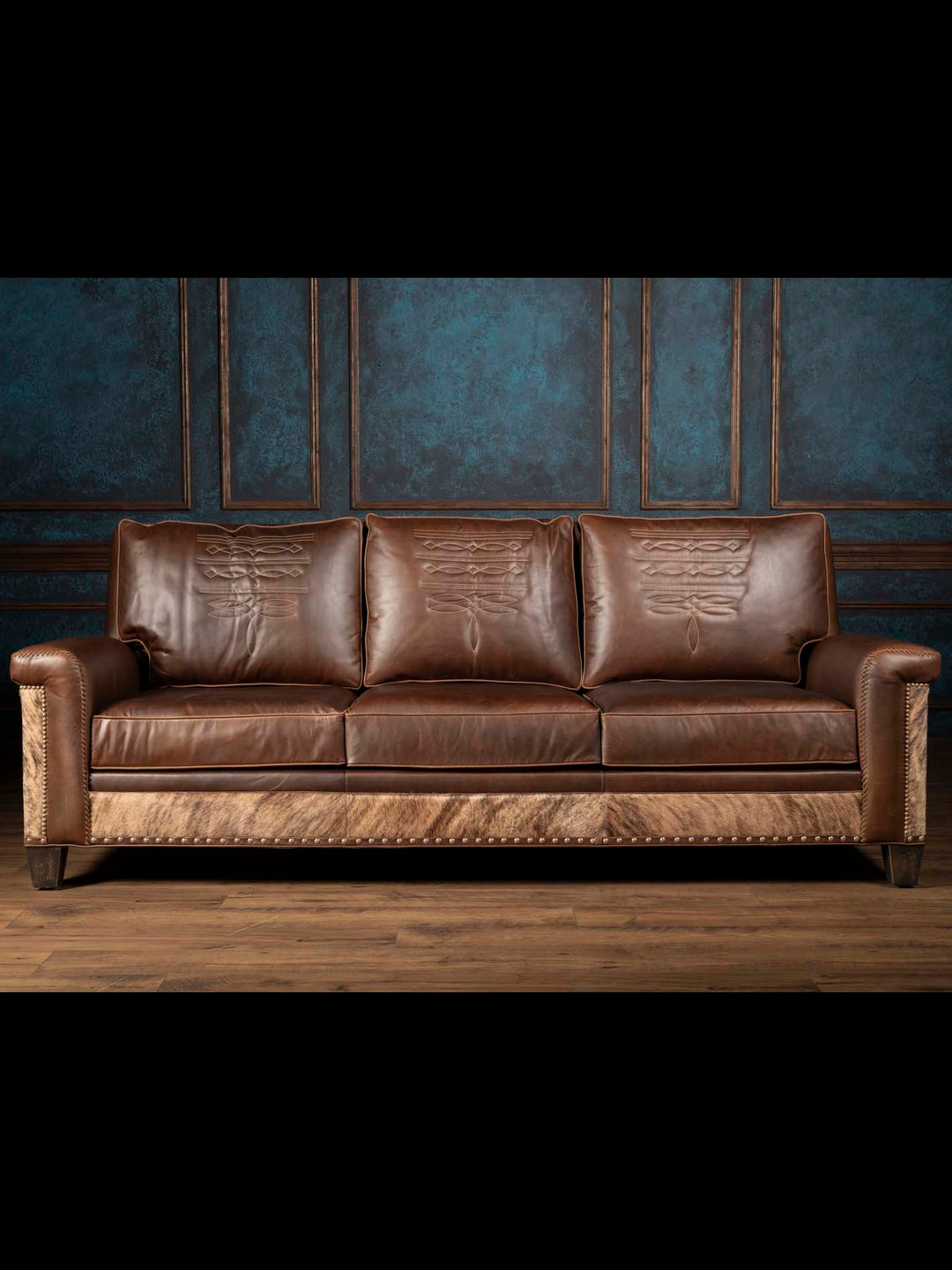 Western Heritage Leather Sofa with cowhide detailing in a western style living space.