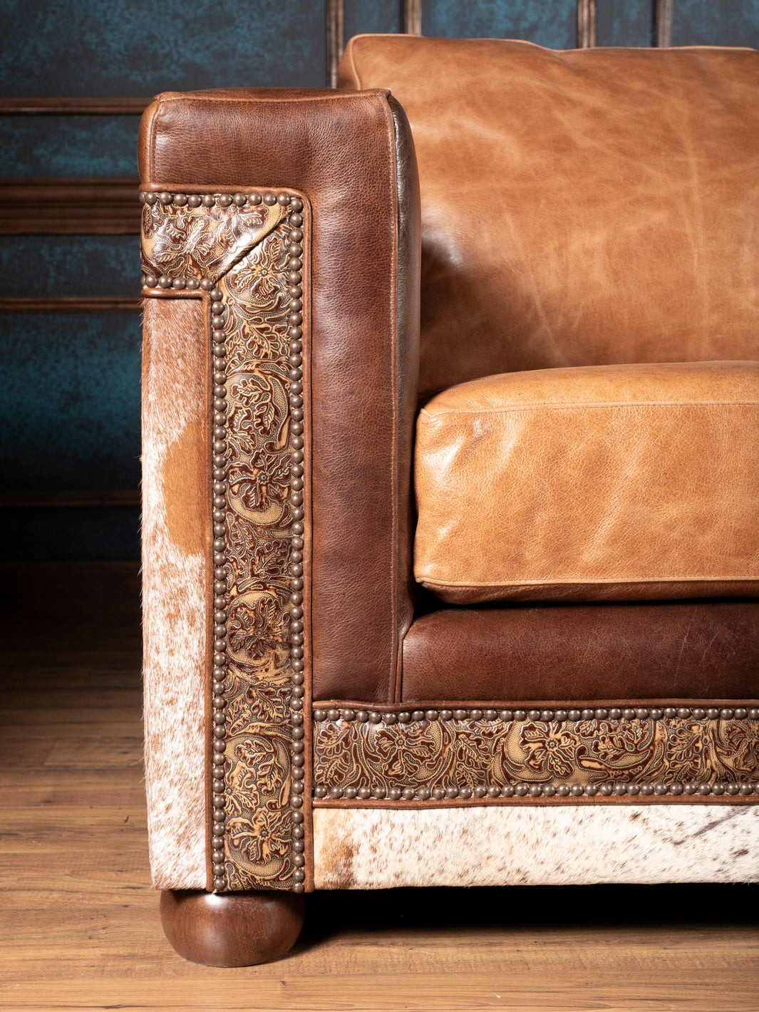 hand-tooled leather trim on rustic leather sofa arm