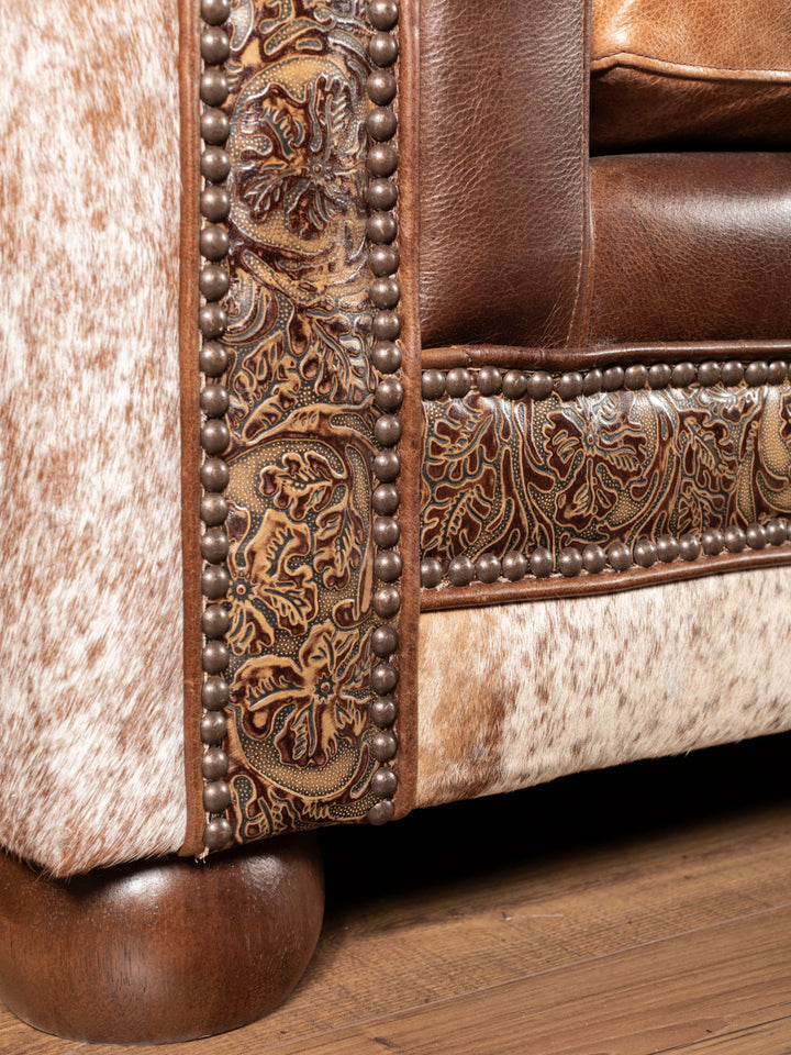 rustic western cowhide sofa hand-tooled border closeup