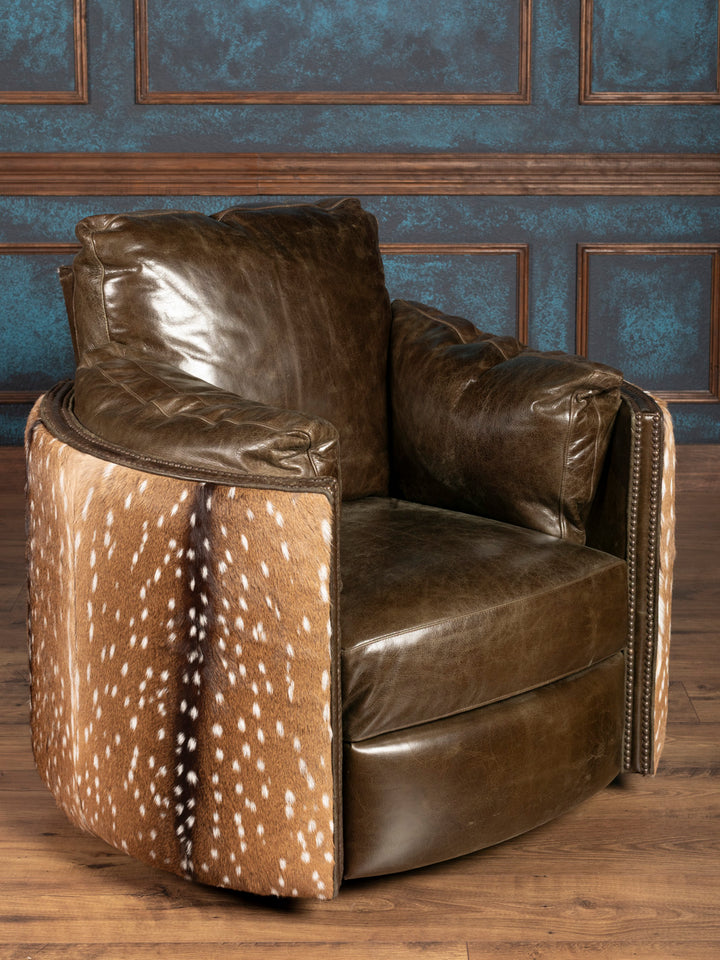 forest green leather armchair with deer hide pattern against a blue paneled wall.