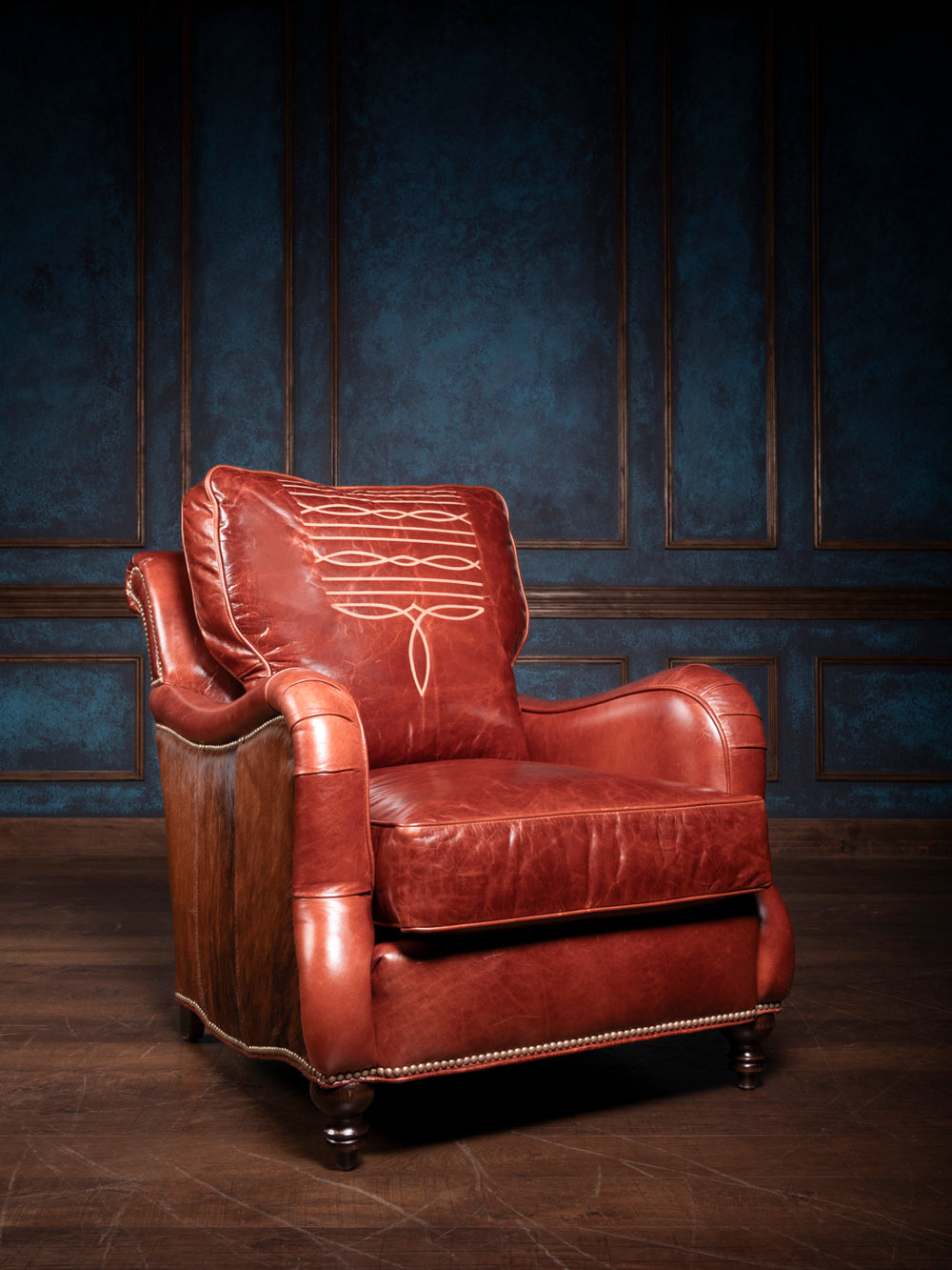 Amarillo Red Stitch Accent Chair in Mont Blanc leather with hair-on-hide accents in a living space.
