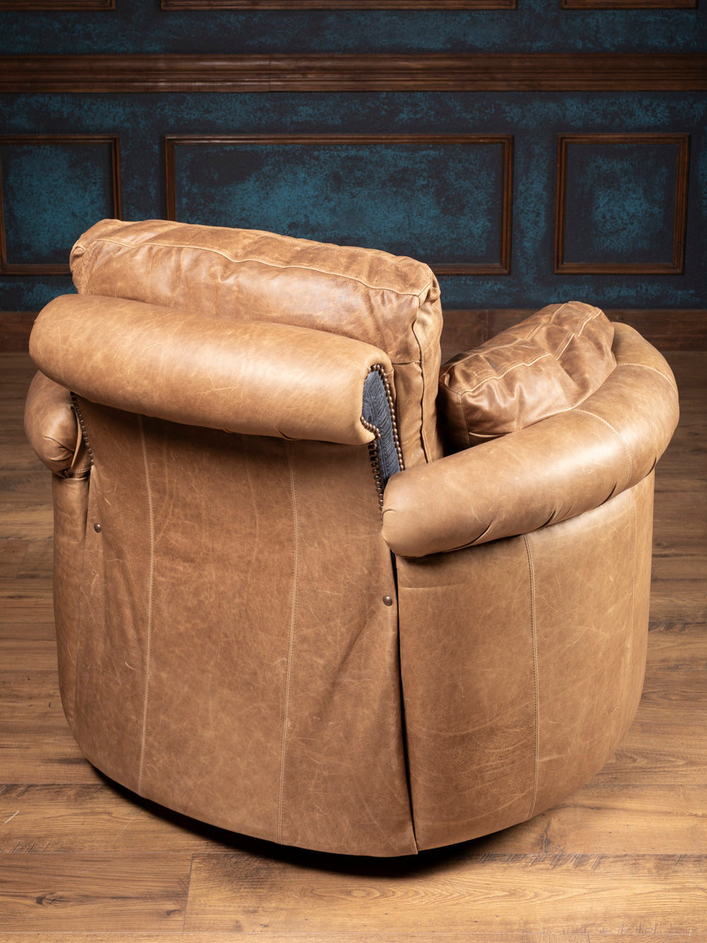 Back view of the handcrafted Amber Range Leather Snug Swivel Recliner in warm amber-toned leather.