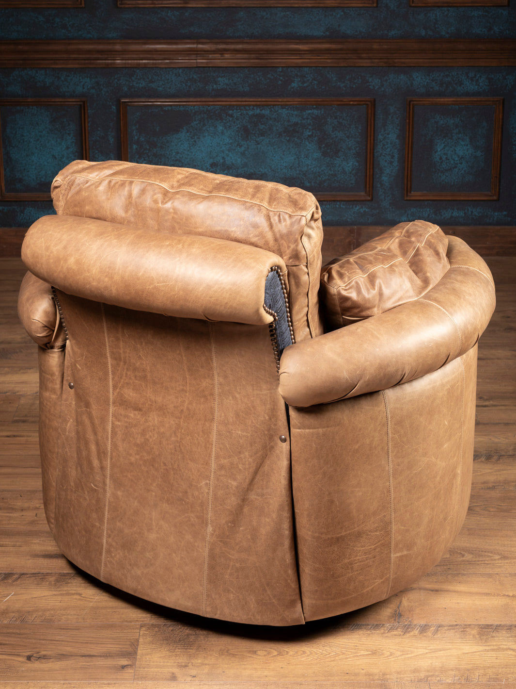 Back view of the handcrafted Amber Range Leather Snug Swivel Recliner in warm amber-toned leather.