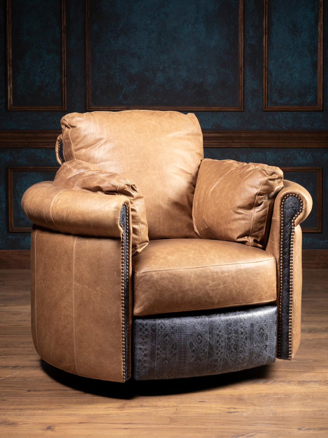 The Amber Range Leather Snug Swivel Recliner, a handcrafted Western leather recliner with a rolled arm silhouette, shown from the front.