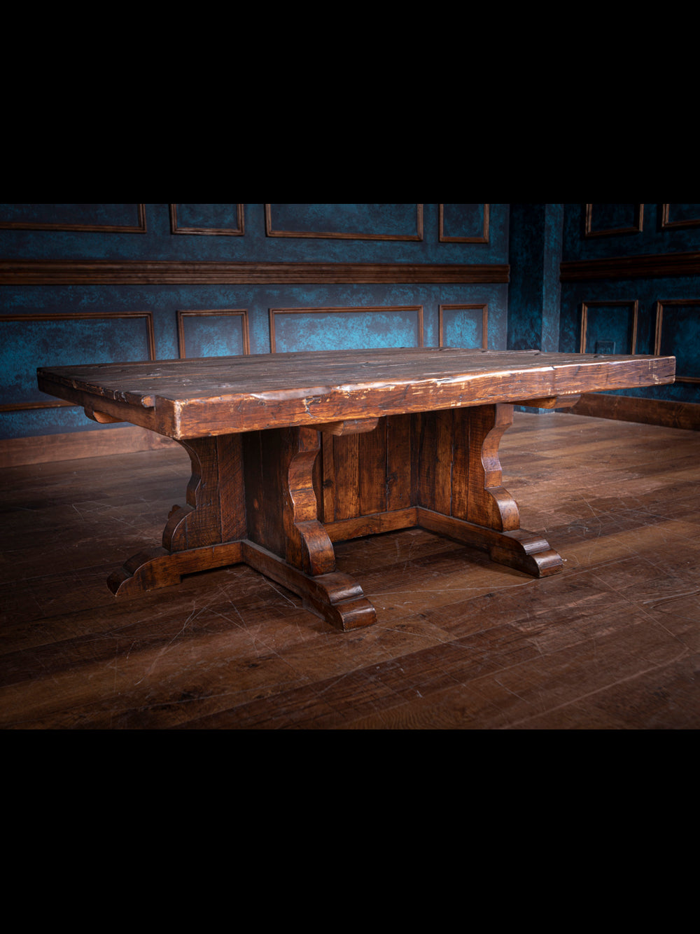 Wooden table in a dimly lit room with paneled walls.