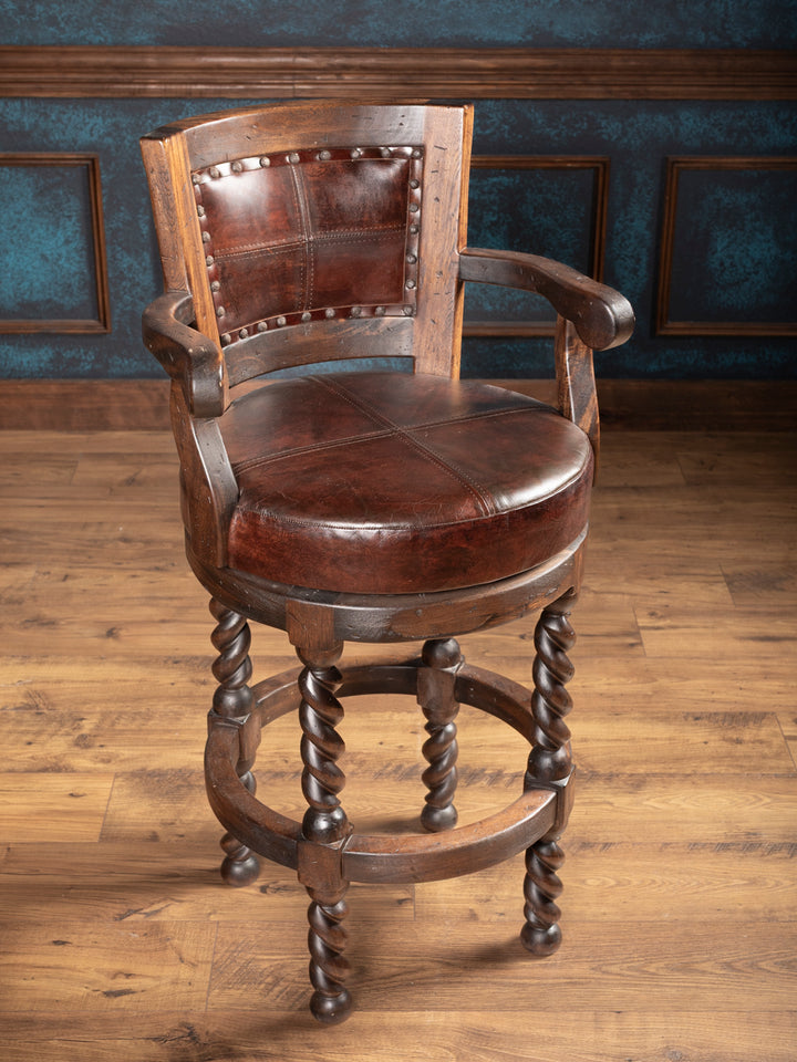 Wooden bar stool with leather seat and backrest in a room with wooden floor and blue walls.