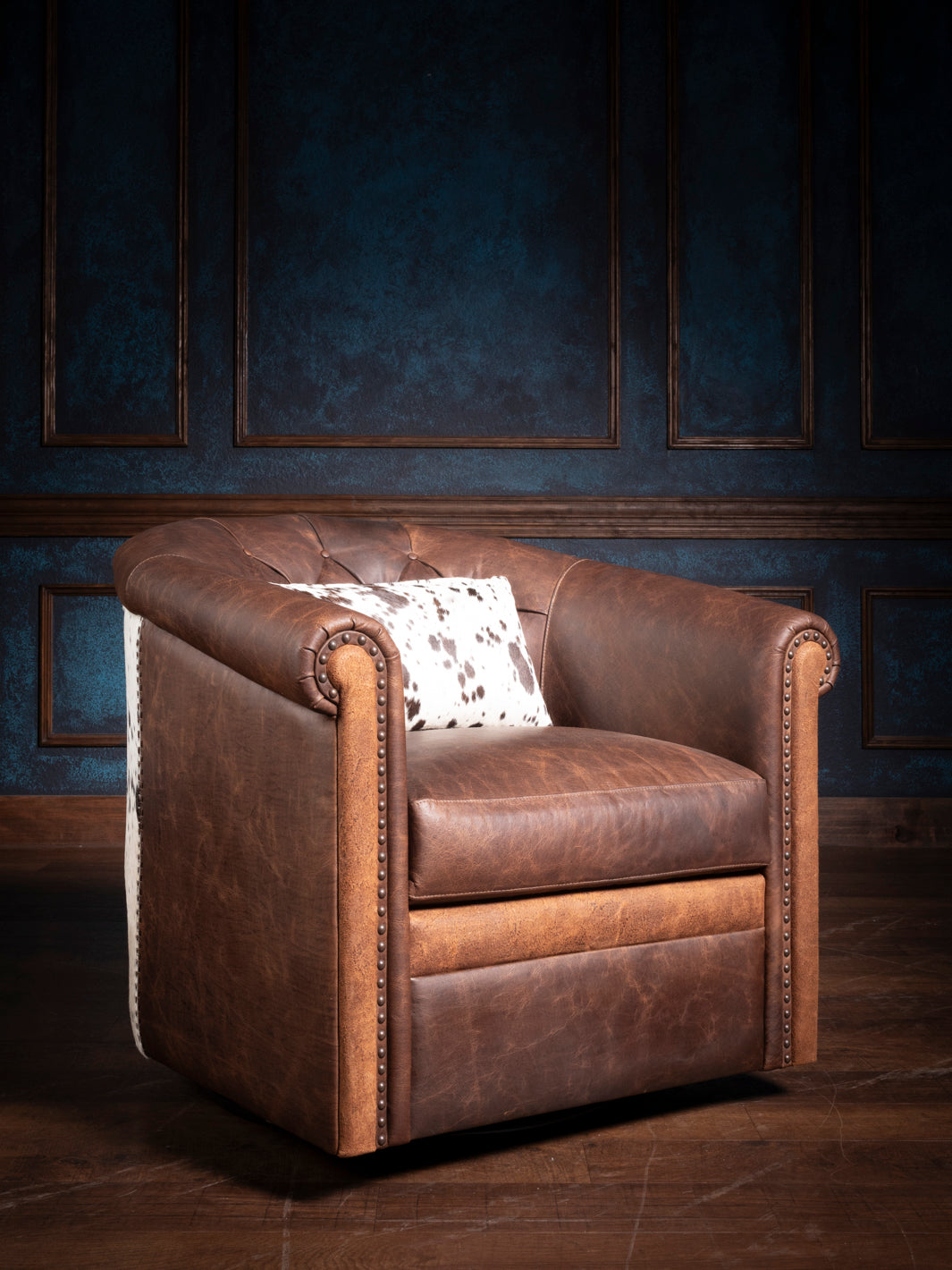 Side view showcasing the rich texture and tufted back of the Bison Ridge leather chair, accented with sophisticated nailhead details.