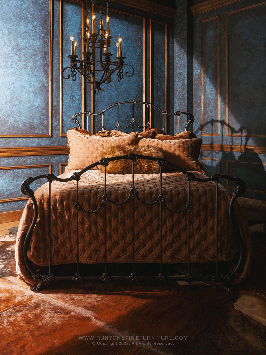 Decorative bedroom with ornate bed and chandelier, featuring Runyon's Fine Furniture branding.