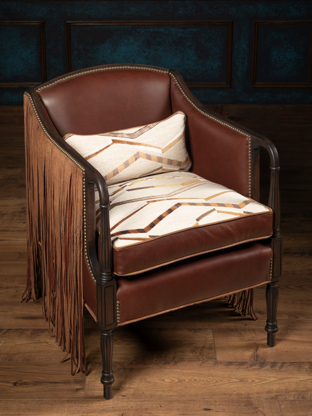 High-angle front view of the Boulder Western leather accent chair handcrafted in the USA featuring a reversible southwestern geometric print cushion and warm cognac leather.