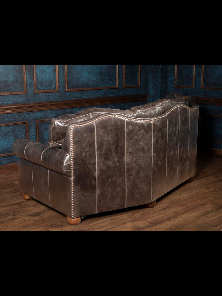 Rear view of the Brazos handcrafted Western leather sofa featuring premium full-grain buffalo leather, curved back profile, and artisan craftsmanship.