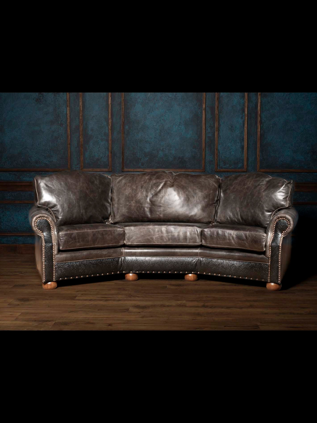 Handcrafted Western leather sofa upholstered in full-grain buffalo leather with hand-tooled leather accents, rolled arms, and a curved silhouette.