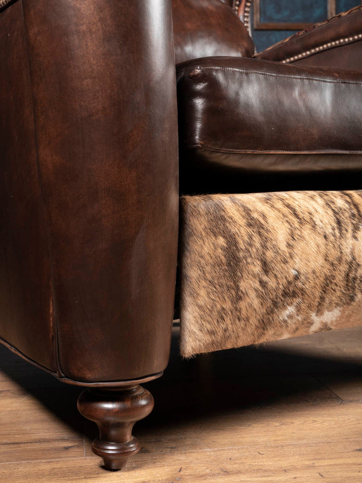 Brindle hair-on-hide and embossed Western leather trim accent detail on the recliner