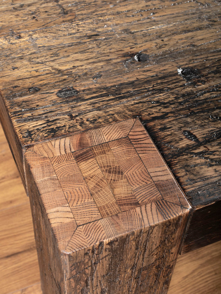 Reclaimed Oak Plank Coffee Table with distressed wood showing natural grain in a close-up view.