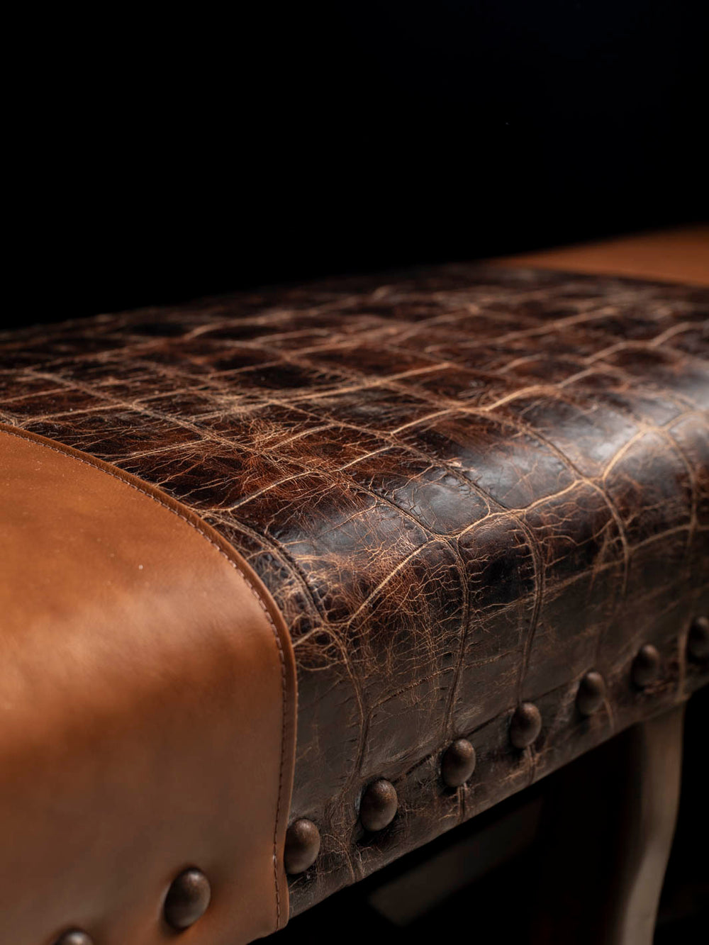 Detailed view of burnished full-grain aniline leather and jumbo crocodile-embossed leather on the Santa Fe handcrafted Western leather bench.