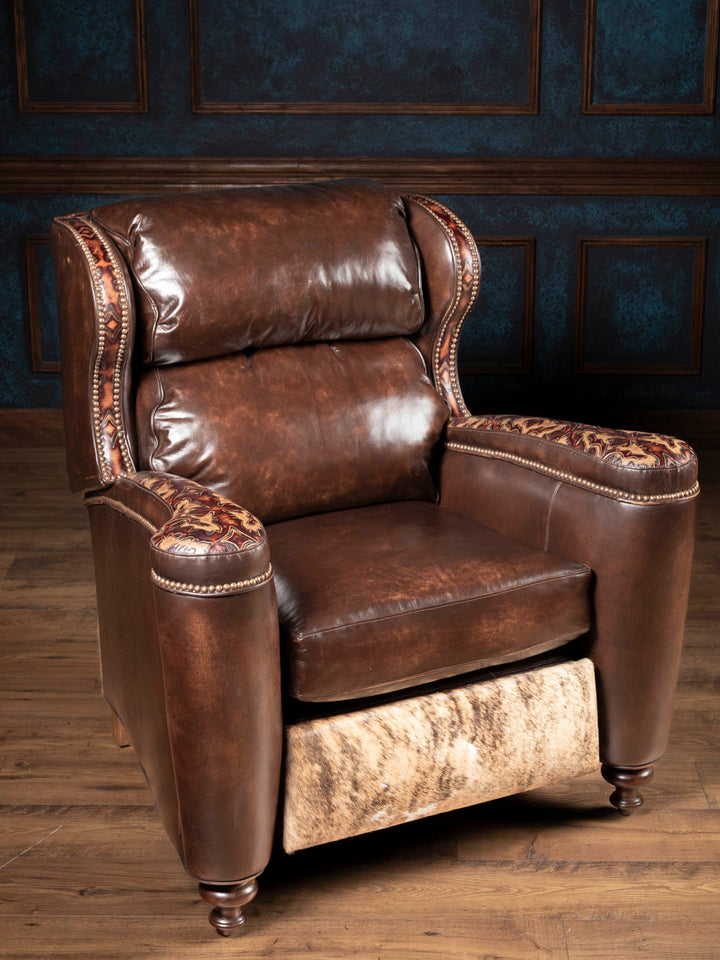 Side angle of the burnished brown leather recliner showing paneled arms and tall back