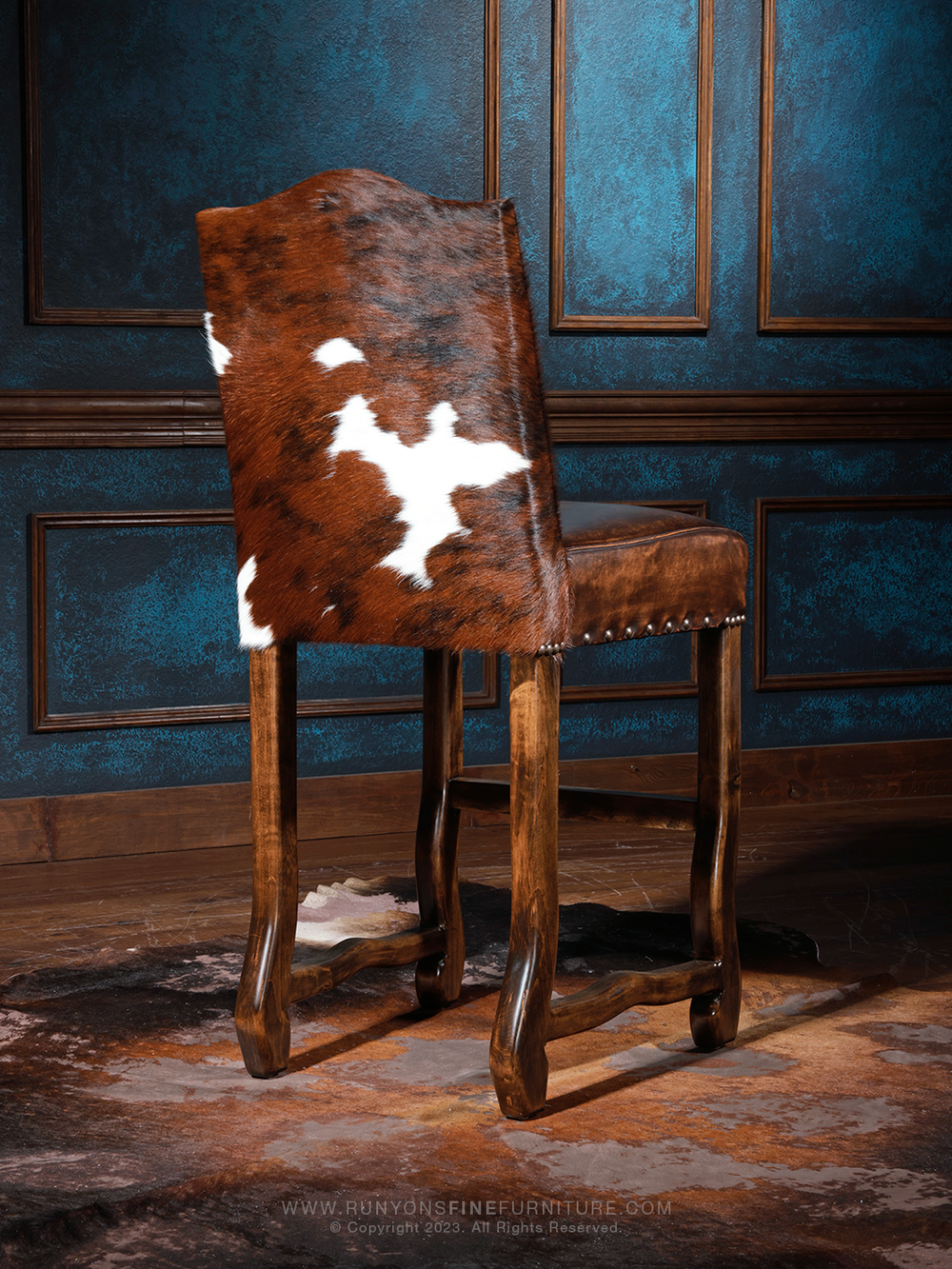 Cattleman’s Cowhide and Leather Bar Stool with brown leather and cowhide accents, styled in a bar room space.