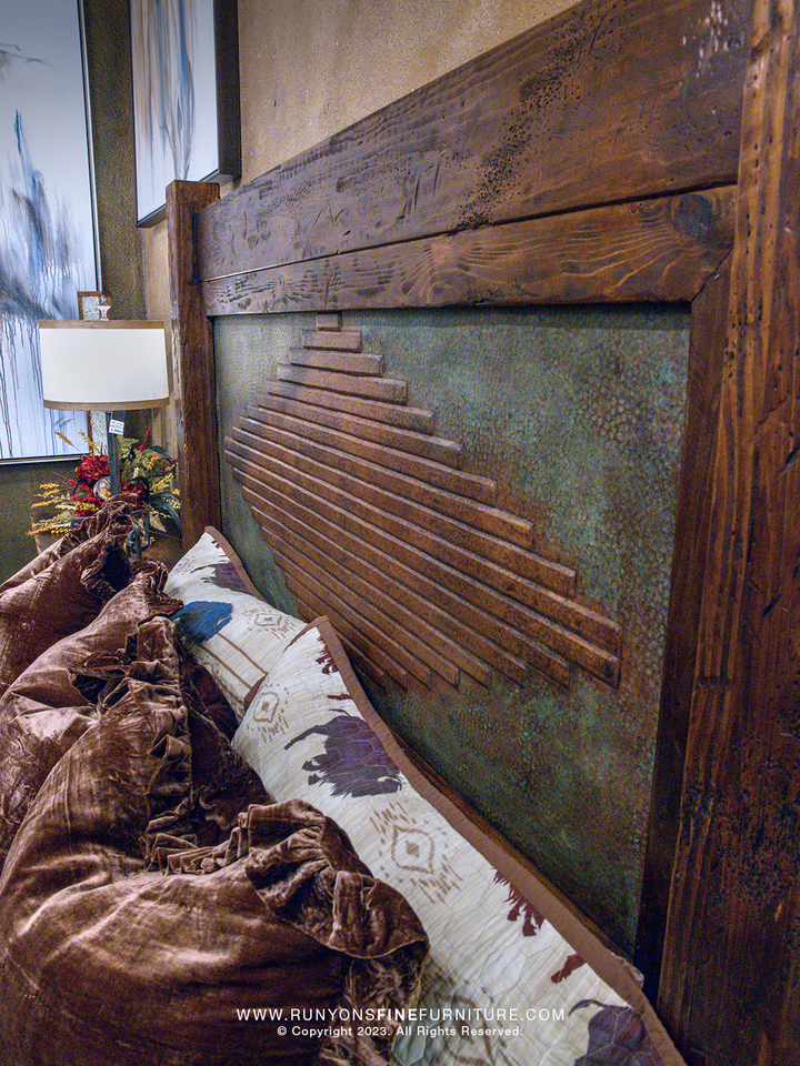 Wooden headboard with copper geometric design in a bedroom setting