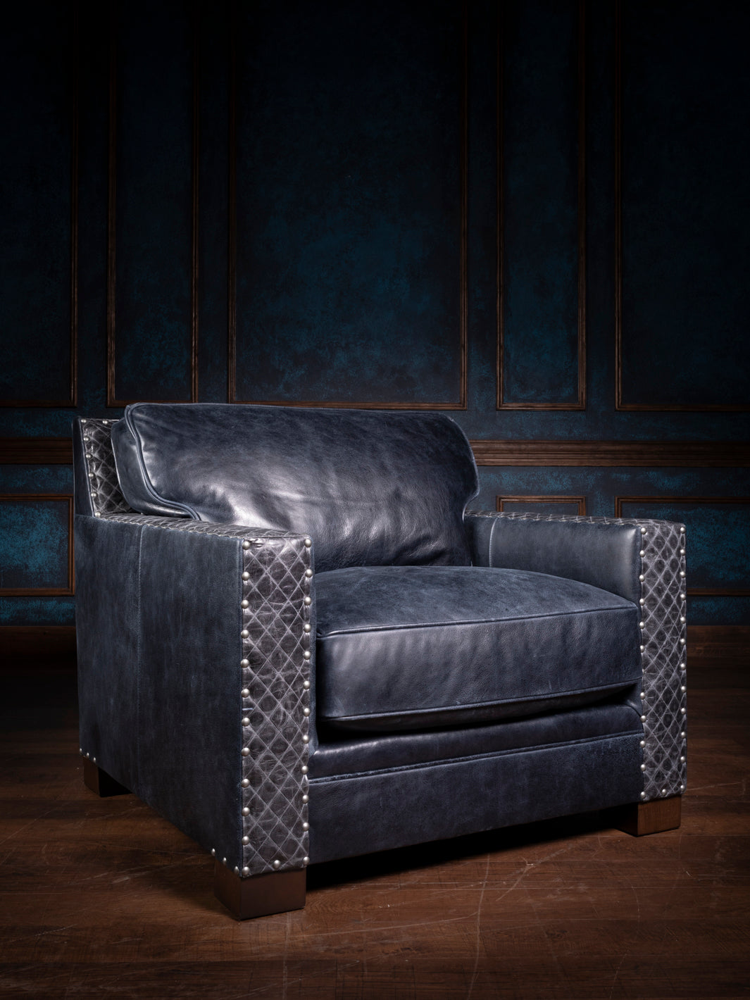 Stylish blue leather chair with quilted design and metallic accents in an opulent room - A stylish blue leather chair with a quilted design and metallic accents, perfectly complementing the opulent wooden panel background, ideal for luxurious interiors.