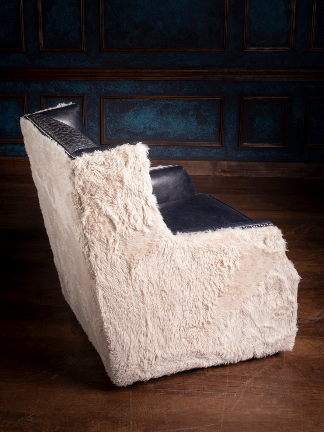 Side View of Cowboys Blue Leather Swivel Chair with Shearling Upholstery - Western Furniture Design Featuring Plush Leather and Natural Textures, Perfect for Cozy Spaces