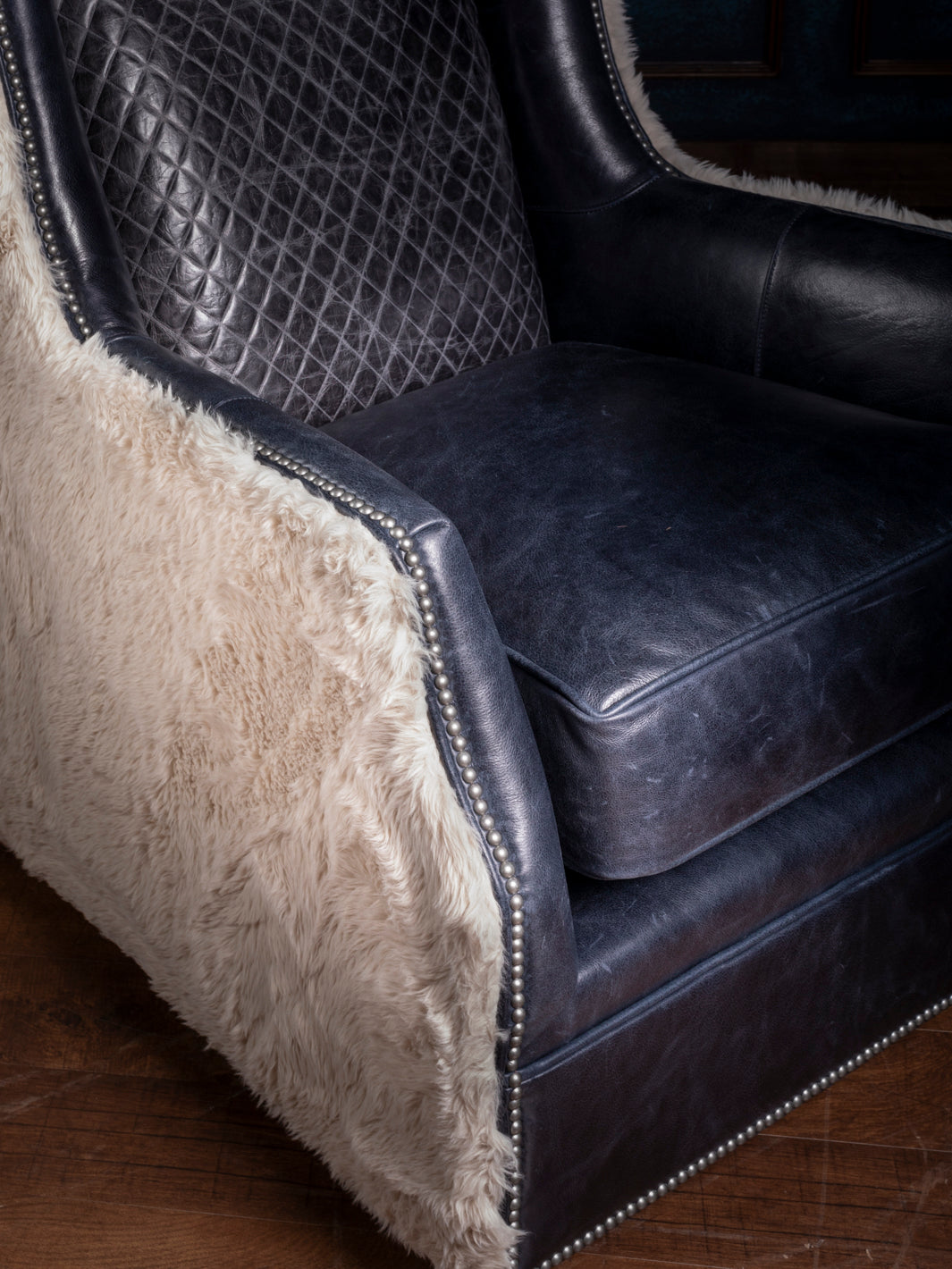 Detailed View of Cowboys Blue Leather Swivel Chair with Quilted Back and Soft Shearling Upholstery - Luxurious Western Furniture for Sophisticated Interiors.