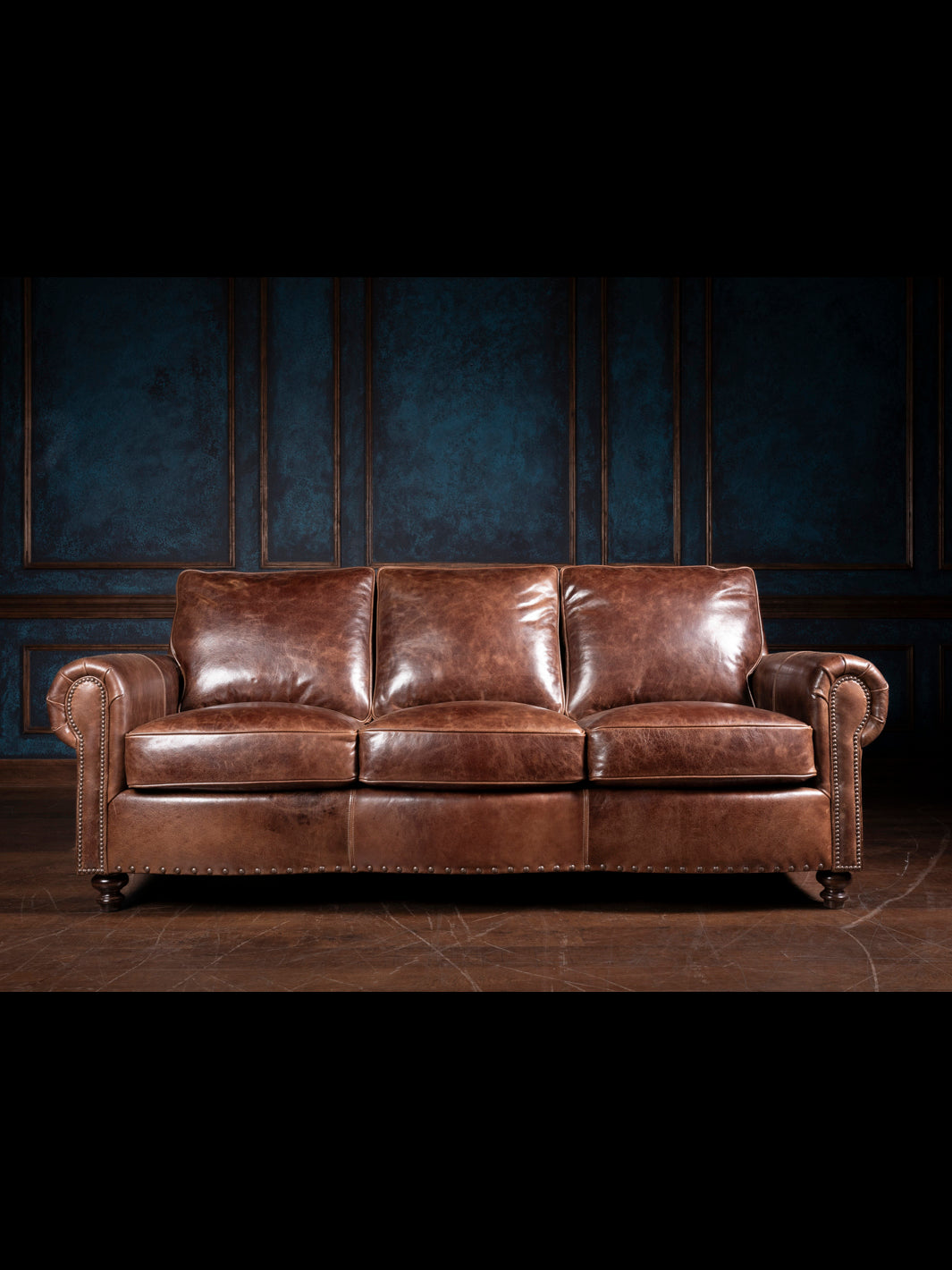 Dark Rum Rolled Arm Sofa in brown full grain leather with a classic rolled arm design in a western living room.