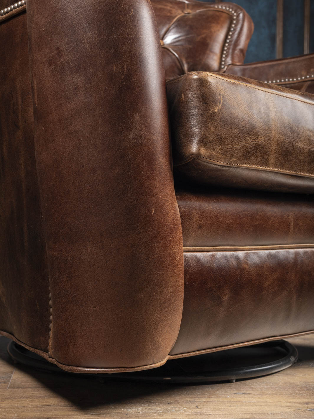 Hidden 360-degree swivel base on the Dark Rum tufted leather swivel chair
