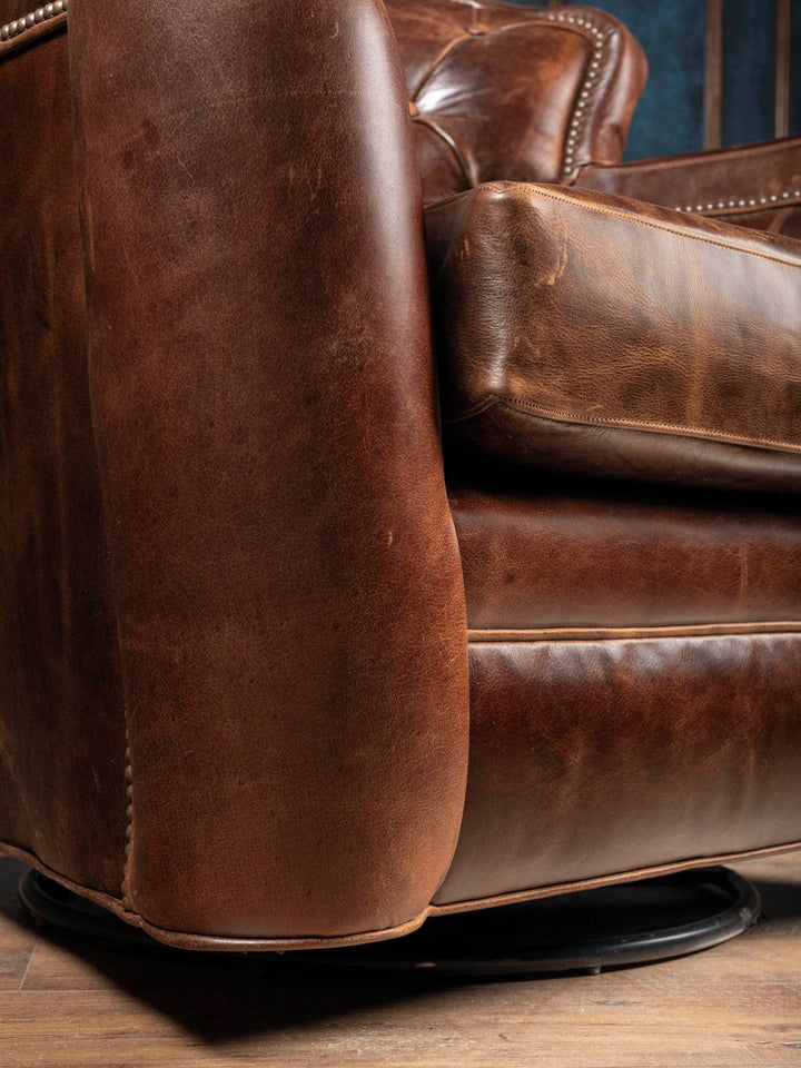 Hidden 360-degree swivel base on the Dark Rum tufted leather swivel chair