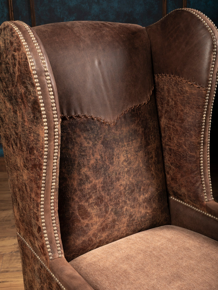 Distressed brown leather accent chair with embossed leather and western yoke detailing.