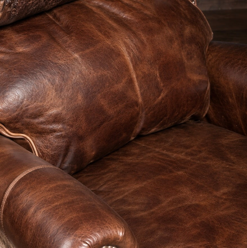 Rich brown distressed leather sofa showing deep patina, visible grain and natural colour variation