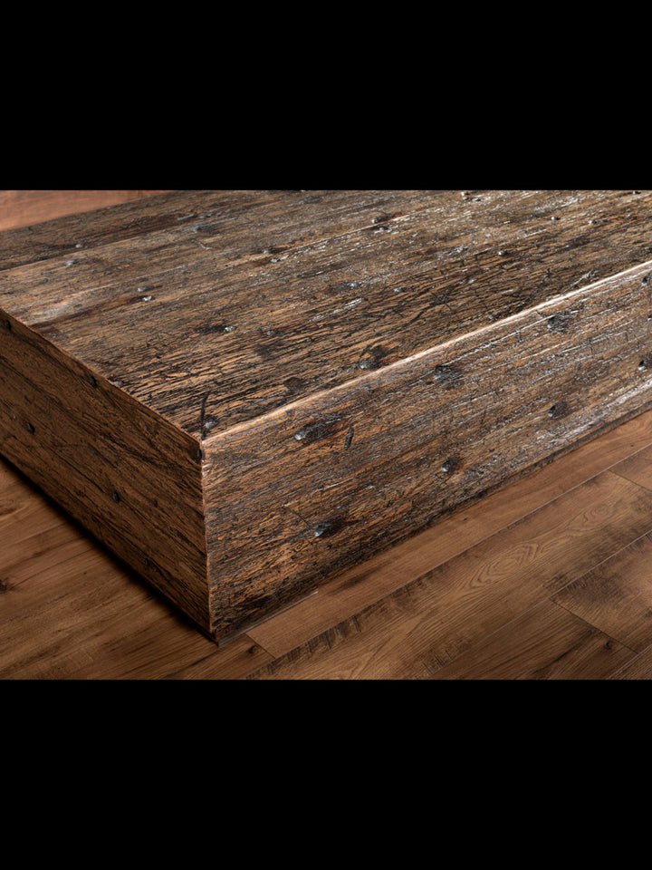 Reclaimed Oak Beam Coffee Table with natural distressed wood in a brown finish.