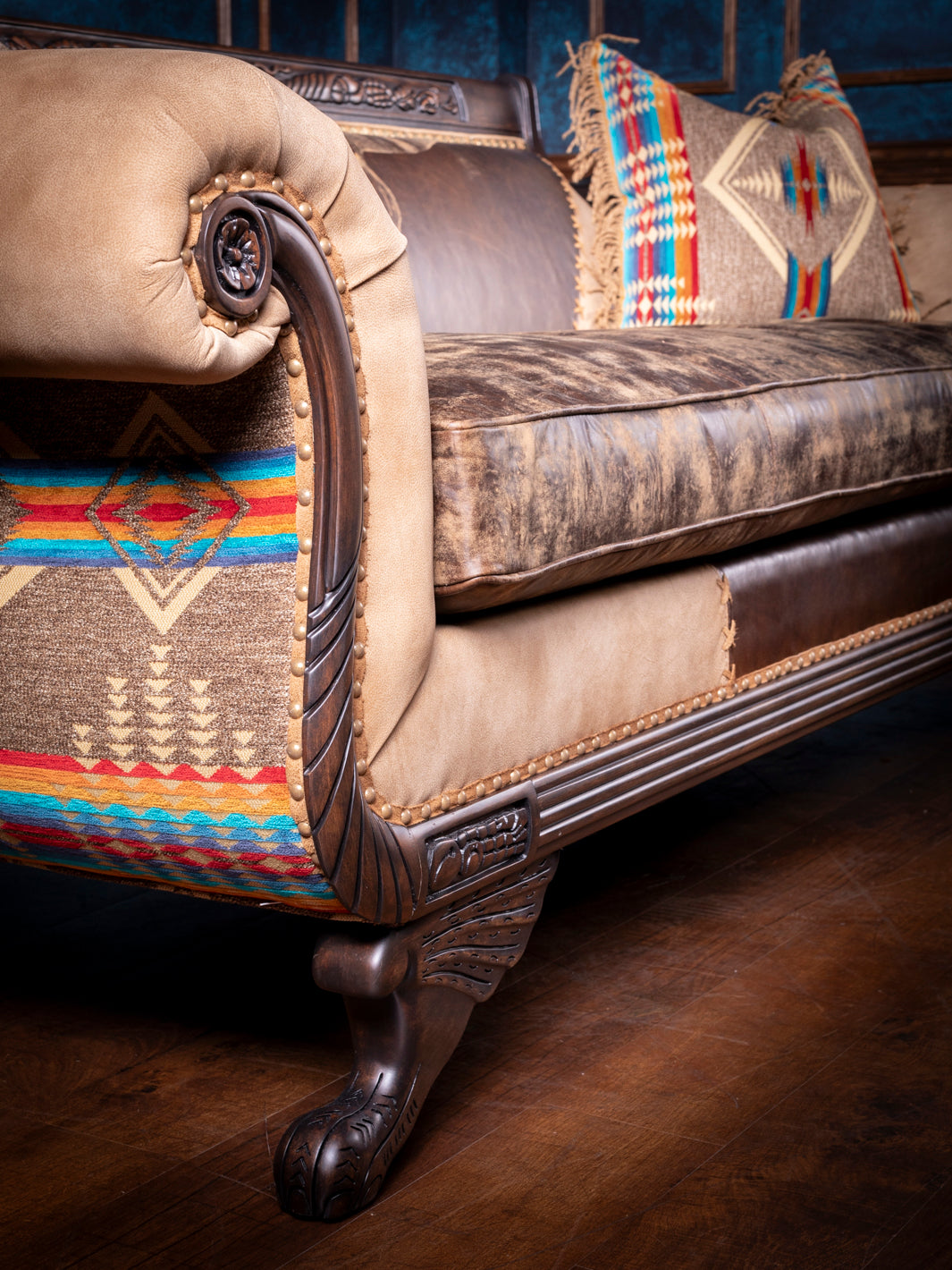 Duncan Phyfe Steer Leather Sofa with distressed leather  seats and western accents in a close up view. 