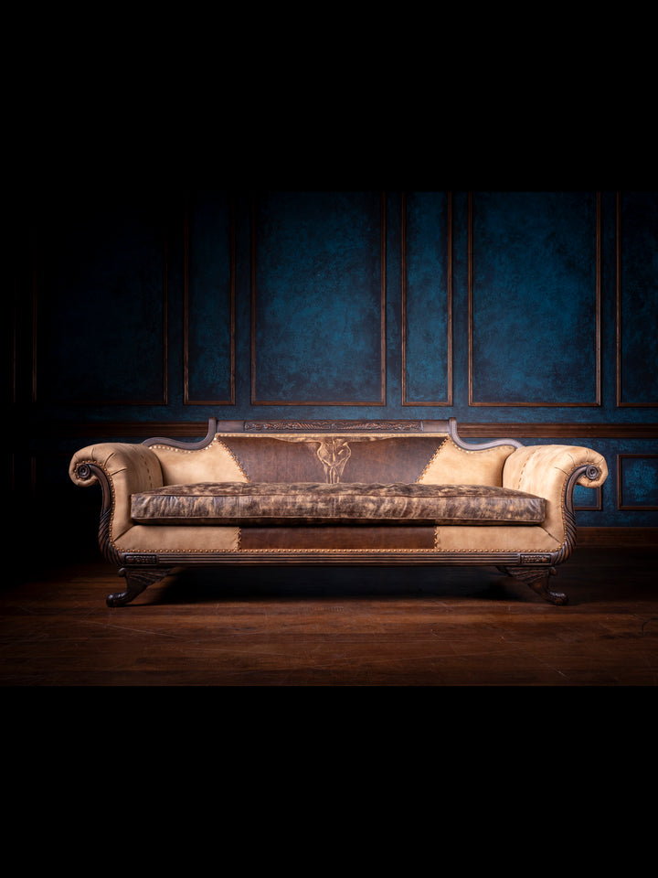 Duncan Phyfe Steer Leather Sofa with distressed brown leather seats and western design accents in a living space.