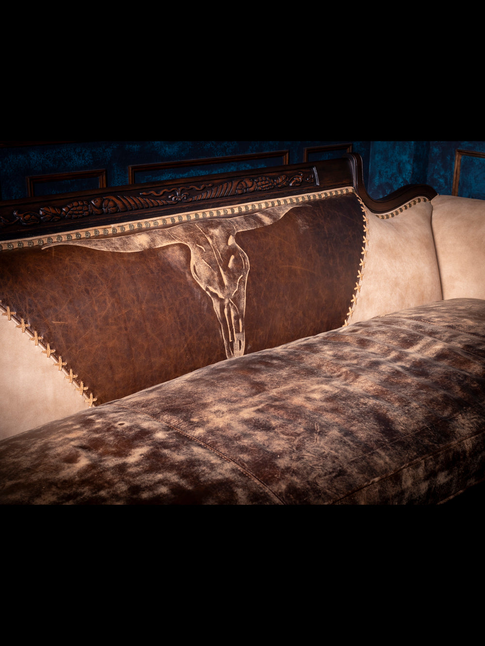 Duncan Phyfe Steer Leather Sofa with embossed steer skull on inside back in a close up view.